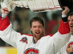 In this June 9, 1993, file photo, Montreal Canadiens goalie Patrick Roy hoists the Stanley Cup Trophy after the Canadiens defeated the Los Angeles Kings in Montreal to win the Stanley Cup. (AP Photo/The Canadian Press, Ryan Remiorz, File)