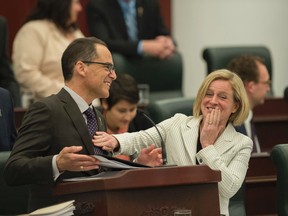 Alberta Minister of Finance Joe Ceci delivered the 2016 Budget at the Alberta Legislature. Before the budget was read, Ceci and Premier Rachel Notley share a light moment. (Shaughn Butts)