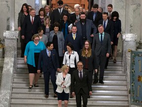 Premier Rachel Notley and President of Treasury Board and Minister of Finance, Joe Ceci, as well as other members of the NDP, walk down the steps in theAlberta Legislature after he delivered the budget on April 14, 2016 in Edmonton. (Greg Southam)