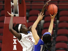 Adut Bulgak, left, shown here blocking a shot by Middle Tennessee's Brea Edwards during a game in March, was taken 12th overall by the New York Liberty in Thursday's WNBA draft. (AP Photo)