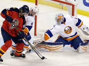 New York Islanders goalie Thomas Greiss blocks a shot as Calvin de Haan (44) defends Florida Panthers winger Jaromir Jagr (68) Thursday, April 14, 2016, in Sunrise, Fla. (AP Photo/Alan Diaz)