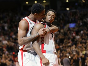 Toronto Raptors Kyle Lowry gets a hug from DeMar DeRozan during a game against the Cleveland Cavaliers at the Air Canada Centre in Toronto on Feb. 26, 2016. (Stan Behal/Toronto Sun/Postmedia Network)