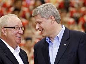 Canada's Prime Minister Stephen Harper shakes hands with former Montreal Canadiens coach Jacques Demers at Laval University in Quebec City on  Aug. 27, 2009. (REUTERS/Mathieu Belanger)