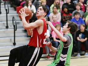 Nicholas Burke, left, of Northeastern Cougars, drives to the basket against Ashton Martel, of Princess Anne Panthers, at the Rainbow District School Board elementary school boys championship game at Northeastern Elementary School in Garson, Ont. on Wednesday April 13, 2016. The Cougars won 35-27. Burke had a tremendous game where he scored 32 of his team's 35 points. John Lappa/Sudbury Star/Postmedia Network