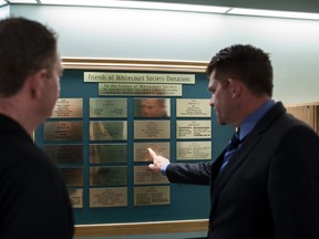 Wildrose MLA Brian Jean and Woodlands County Mayor Jim Rennie read the list of donations made by the Friends of Whitecourt Society through sales at the Repeat Boutique on August 25, 2015