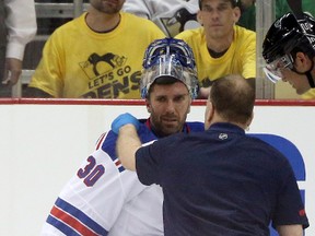 Rangers goalie Henrik Lundqvist is attended to by a trainer after suffering an eye injury during the first period in Game 1 of their playoff series against the Penguins in Pittsburgh on Wednesday, April 13, 2016. (Charles LeClaire/USA TODAY Sports)