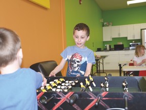 Youngsters play fooseball at the Laugh and Learn Academy in Spruce Grove on April 11. The newly opened out-of-school care centre is one of several day cares in the community, which have noted numbers fluctuating due to the economic times. Photo by Marcia Love