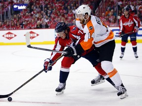 Capitals right wing T.J. Oshie (left) and Flyers centre Sean Couturier (right) go for the puck during Game 1 of their first-round NHL playoff series in Washington on Thursday, April 14, 2016. (Alex Brandon/AP Photo)