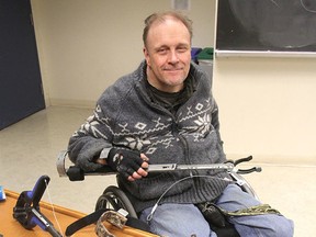 Neil Allen, at Queen's University in Kingston, Ont. on Friday, April 15, 2016, checks out the assistive devices built for him by Queen's first-year engineering students as a course project. He is a quadriplegic and has trouble picking dropped objects off the ground. Michael Lea The Whig-Standard Postmedia Networkk