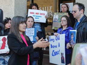 Kingston and the Islands MPP Sophie Kiwala speaks to protestors outside her office in Kingston, Ont. on Friday April 15, 2016. The province wide protests are the result of the Ontario Liberals recent announcement of changes to the programs available to families with autistic children.Julia McKay/The Whig-Standard/Postmedia Network