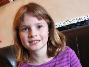 Nine-year-old Marin Feniak poses with part of a recent science fair project wherein she tested milkweed for its oil-absorbing abilities. The Plympton-Wyoming girl is hoping to encourage more milkweed planting in Sarnia-Lambton. (Tyler Kula/Sarnia Observer/Postmedia Network)