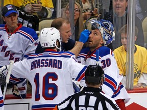 New York Rangers goalie Henrik Lundqvist is attended to by a trainer after getting a stick to the face during first-round NHL playoff action against the Pittsburgh Penguins in Pittsburgh on April 13, 2016. (AP Photo/Gene J. Puskar)