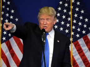 Republican U.S. presidential candidate Donald Trump points to a supporter as he speaks at a campaign rally, Friday, April 15, 2016, in Plattsburgh, N.Y. (AP Photo/Elise Amendola)