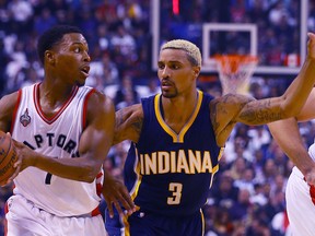 Kyle Lowry of the Toronto Raptors gets around George Hill of the Indiana Pacers during NBA action at the Air Canada Centre in Toronto on Wednesday, October 28, 2015. (Dave Abel/Toronto Sun/Postmedia Network)