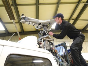 Nick Besserer, an aircraft maintenance engineer at Skyline Helicopter Technologies based in Lively, Ont., works in the shop. A press conference announcing details of an agreement between Skyline and Sikorsky was held on Friday April 15, 2016. John Lappa/Sudbury Star/Postmedia Network