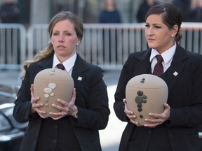 Urns containing the remains of Jean Lapierre and Nicole Beaulieu are carried into the church for their funeral in Montreal, Saturday, April 16, 2016. THE CANADIAN PRESS/Graham Hughes