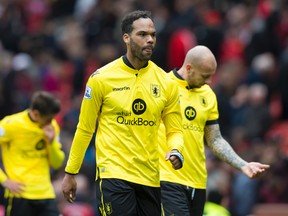 Aston Villa captain Joleon Lescott walks from the pitch with teammates as their team is relegated from the English Premier League after being defeated 1-0 by Manchester United at Old Trafford Stadium, Manchester, England, on Saturday, April 16, 2016. (Jon Super/AP Photo)