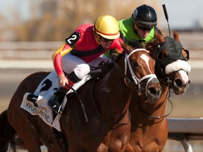 Luis Contreras guides Treasuring (inside rail) to a win over Jennifer Lynette in the Star Shoot Stakes on April 16 at Woodbine. (Michael Burns/photo)