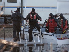 OPP officers, including divers, make their way to a dock at Victoria Place after searching for missing canoeist Angel Villeneuve-Steadman, 28, of Halton Hills, in this picture from April 5. The body of her friend Spencer Dunn, 23, of Scarborough, was pulled from the water earlier that day. Her body was found Saturday, hours before friends and family held a memorial for Dunn. Jonathan Nevins, 19, was lone survivor of the canoe capsizing on Pigeon Lake, north of Peterborough. (Jason Bain/Peterborough Examiner/Postmedia Network)