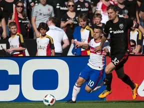 Reds' forward Sebastian Giovinco and D.C. United defender Bobby Boswell battle for position during the first half on Saturday in Washington, D.C.. (USA TODAY SPORTS/PHOTO)