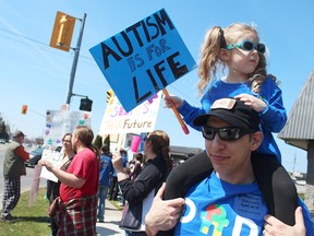 Lilianna and Mark Bagnulo rally for change at an Ontario Autism Coalition protest outside MPP Jim Bradley's office in St. Catharines on April 15. (Maryanne Firth/St. Catharines Standard/Postmedia Network)