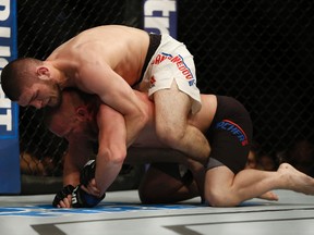 Darrell Horcher (blue gloves) fights Khabib Nurmagomedov (red gloves) in the catchweight bout (bout 9) during UFC Fight Night at Amalie Arena. (Reinhold Matay-USA TODAY Sports)