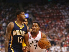 Toronto’s Kyle Lowry (right) tries to get by Pacers star Paul George at the ACC yesterday. George scored 17 points in the third quarter and finished the game with 33.(Michael Peake/Toronto Sun)