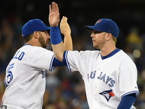 Chris Colabello (left) and Justin Smoak celebrate after a Blue Jays win on Aug. 12, 2015.The two players are slumping at the plate during the early part of the 2016 season. (DAN HAMILTON/USA TODAY Sports files)