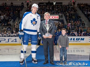 Marlies captain Andrew Campbell poses with — but doesn’t come close to touching — the Macgregor Kilpatrick Trophy, given to the AHL’s top team in the regular season. The trophy is presented by league president Dave Andrews. (CHRISTIAN BONIN/Photo)