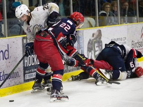 The Spruce Grove Saints' Nicolas Correale (28) battles the Brooks Bandits' Parker Foo (22) during second period AJHL action at Grant Fuhr Arena, in Spruce Grove Alta. on Saturday April 16, 2016. This was game 2 of the 2016 Alberta Junior Hockey League Gas Drive Cup.