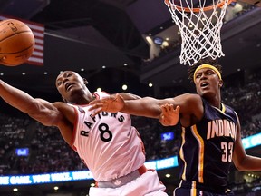 Toronto Raptors' Bismack Biyombo reaches to grab the rebound away from Indiana Pacers' Myles Turner during first half round one NBA basketball playoff action in Toronto on Saturday, April 16, 2016. (THE CANADIAN PRESS/Frank Gunn)