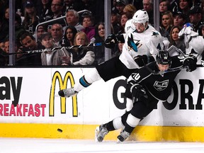 Sharks’ Brenden Dillon, (left) takes out Kings’ Kris Versteeg during Game 2. The series moves back to San Jose tonight.
