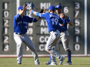 Blue Jays outfielder Jose Bautista (centre) celebrates with new leadoff hitter Michael Saunders (left) and former leadoff hitter Kevin Pillar after their team’s win over Boston. (BOB DeCHIARA/USA Today Sports)