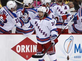 New York Rangers' Mats Zuccarello celebrates as he returns to the bench after scoring against the Pittsburgh Penguins during the second period of Game 2 in the first round of the NHL Stanley Cup playoffs in Pittsburgh, Saturday, April 16, 2016. (AP Photo/Gene J. Puskar)