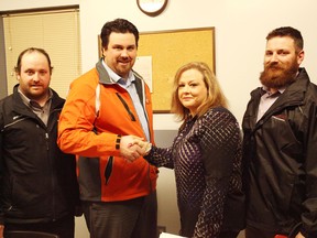 From the left is Matt Flessatti, T.J. Runhart, Lisa Campbell and Tom Flessatti at the Seaforth & District Community Centre. Runhart and Campbell shake hands. making the Seaforth Generals the newest team in the Huron East area.(Shaun Gregory/Huron Expositor)