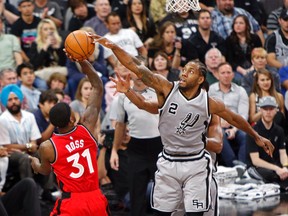 San Antonio Spurs forward Kawhi Leonard (2) blocks the shot of Toronto Raptors’ Terrence Ross Saturday, April 2, 2016, in San Antonio. (AP Photo/Michael Thomas)