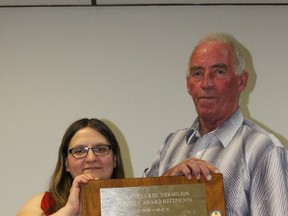 at Calyniuk and Brian Chrisp hold up the Integrity Award plaque.