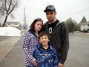 Devin Brousseau, 9, seen here with his parents Robert Brousseau and Ashley Dundas, was reported missing on Monday when he didn't show up to school. Devin, who has a cognitive disability and is unable to speak, was found three hours after he had left home, sitting in a parked school bus where he had been forgotten. Despite a report that the driver and two others have been fired, Devin’s father says they intend to pursue legal action.