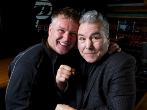 Former Canadian heavyweight boxer George Chuvalo (R) mugs for a photo with StopBully.com support services director Olaf Petersen inside Peanuts Pub in the Carriage House Inn in Calgary, Alta., on Monday, April 18, 2016. He was in town supporting a fundraiser dinner for stopbully.com that would come the next evening in Cochrane. Lyle Aspinall/Postmedia Network