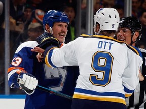 Casey Cizikas of the New York Islanders and Steve Ott of the St. Louis Blues exchange words at the Nassau Veterans Memorial Coliseum on December 6, 2014 in Uniondale, N.Y. (Bruce Bennett/Getty Images/AFP)