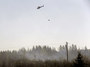 Two helicopters and 25 firefighters are still fighting a brush fire near Duffield, Alberta, a hamlet located approximately 65 km west of Edmonton on April 18, 2016. (LARRY WONG)
