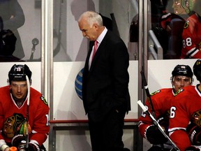 Chicago Blackhawks head coach Joel Quenneville looks down as he watches his team during the third period in Game 3 of an NHL hockey first-round Stanley Cup playoff series against the St. Louis Blues, Sunday, April 17, 2016, in Chicago. (AP Photo/Nam Y. Huh)
