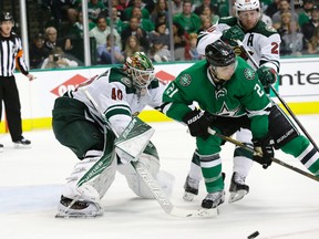 Minnesota Wild goalie Devan Dubnyk defends the goal against Dallas Stars left winger Antoine Roussel during the third period in Game 2 in the first round of the NHL playoffs in Dallas on April 16, 2016. (AP Photo/LM Otero)