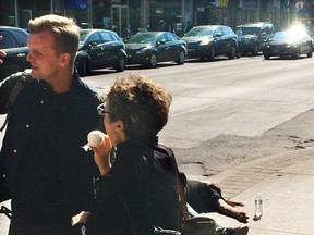 Ward 20 Councillor Joe Cressy speaks to supporters while a homeless man lies behind him on Bloor St. in Toronto Saturday, April 16, 2016. (Supplied)