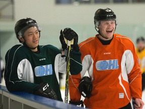 Cliff Pu (left) and Max Jones share a laugh during London Knights practice at Western Fair in London, Ont. on Monday April 18, 2016. (DEREK RUTTAN, The London Free Press)