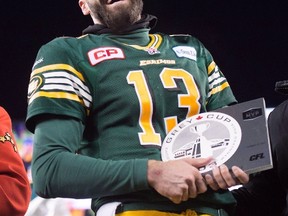 Edmonton Eskimos' quarterback Mike Reilly holds the MVP award after defeating the Ottawa Redblacks to win the 103rd Grey Cup in Winnipeg, Man., Sunday, Nov. 29, 2015. The Eskimos signed Reilly to a contract extension through the 2018 season Thursday. THE
