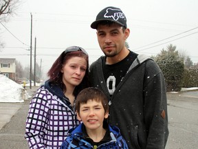 Devin Brousseau, 9, seen here with his parents Robert Brousseau and Ashley Dundas, was reported missing on Monday when he didn't show up to school. Devin, who has a cognitive disability and is unable to speak, was found three hours after he had left home, sitting in a parked school bus where he had been forgotten. (Alan S. Hale/Timmins Daily Press/Postmedia Network)