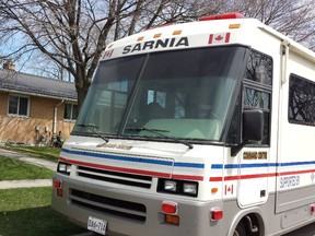 A Sarnia Police command centre sits outside a home where a man's body was found Tuesday. (Paul Morden, Sarnia Observer)