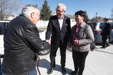 Manitoba NDP Leader and premier Greg Selinger and his wife Claudette greet former city councillor Paul Marion as they leave a polling station after voting in the provincial election in Winnipeg, Tuesday, April 19, 2016. THE CANADIAN PRESS/John Woods