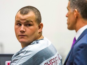 In this Oct. 1, 2015 file photo, accused freeway shooter Leslie Allen Merritt, Jr., appears in Maricopa County Superior Court for his arraignment in Phoenix. Phone records and family interviews show that Merritt, 21, charged in some of the freeway shootings that put Phoenix-area drivers on edge recently, was not near the crime scenes. The freeway shootings were the top story in Arizona in 2015, headlining a list that included connections to terrorism, a fight over education spending, prison riots and the nation's biggest sporting event being held in the state.(Tom Tingle/The Arizona Republic via AP, Pool, File)